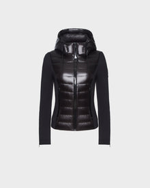 The RUDSAK MABS - 8122020 BLACK women’s puffer jacket features a black hood, shiny front, matte sleeves and sides, is crafted from RDS-certified down, and is shown against a plain white background.