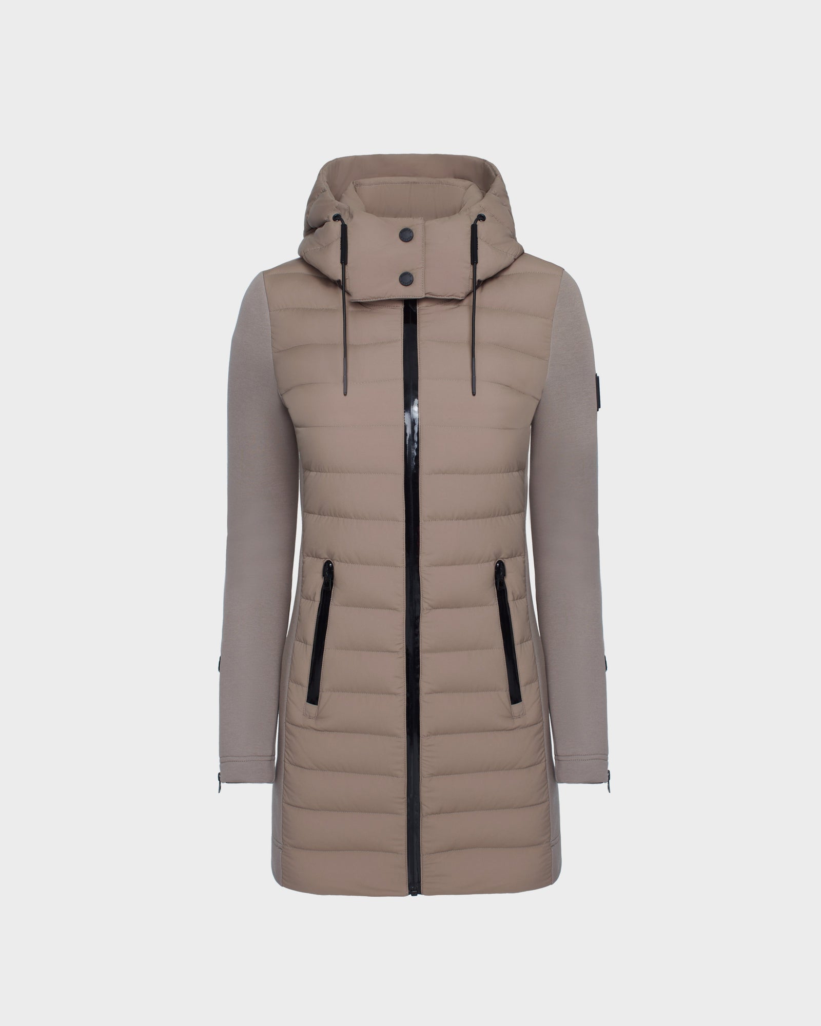 The Rudsak MERINA M - 8124030 Cement is a light brown, knee-length women’s quilted down jacket with a hood, black zippered front and side pockets, long sleeves with smooth texture, and horizontal quilting on the body.