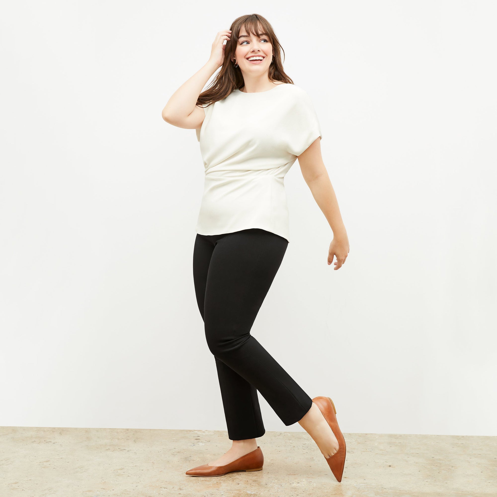 Front image of a woman standing wearing the Foster Pant—Everstretch in Black | Exclude