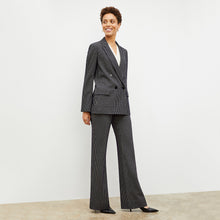 Front image of a woman wearing the horton pant in black and white houndstooth | Lead