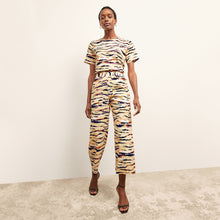 front image of a woman wearing the madelyn pant in savannah print