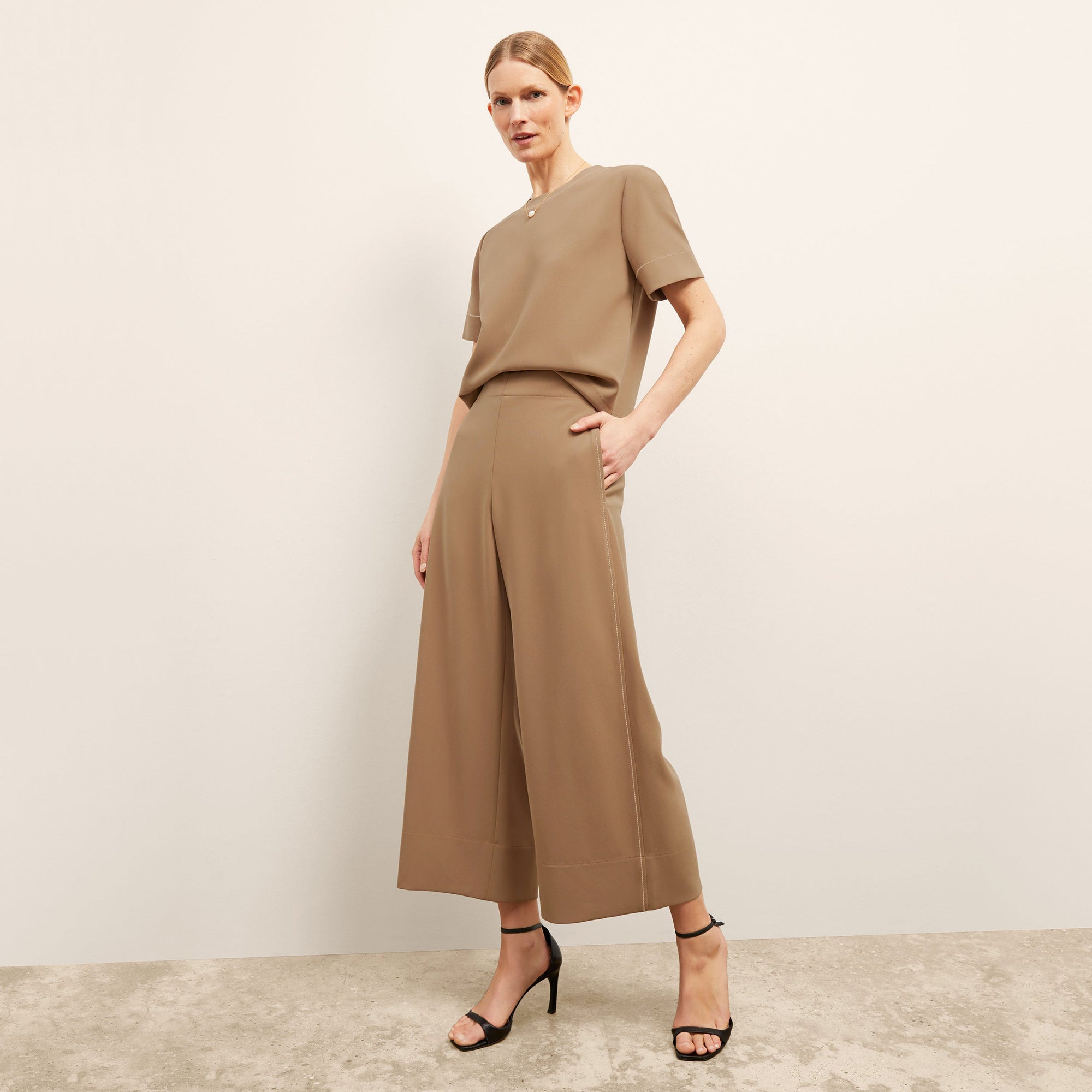 front image of a woman wearing the annika top in saddle