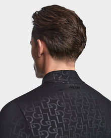 A man with short brown hair is seen from behind, wearing the Rudsak WARREN - 6523502 Black Pattern mens fitted stretch top with a subtle geometric pattern. The background is plain white.