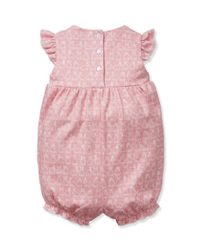 Baby's Pima Isla Play Romper in Hoppy Days Pink features flutter sleeves, ruffled leg openings, a gathered waist, and an allover white bunny outline print. Shown laid flat on a white background.