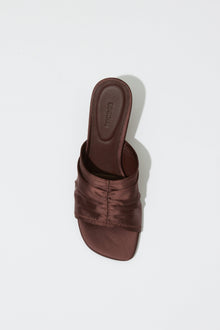 Dark brown satin mule with padded upper strap and square toe, shown from above.