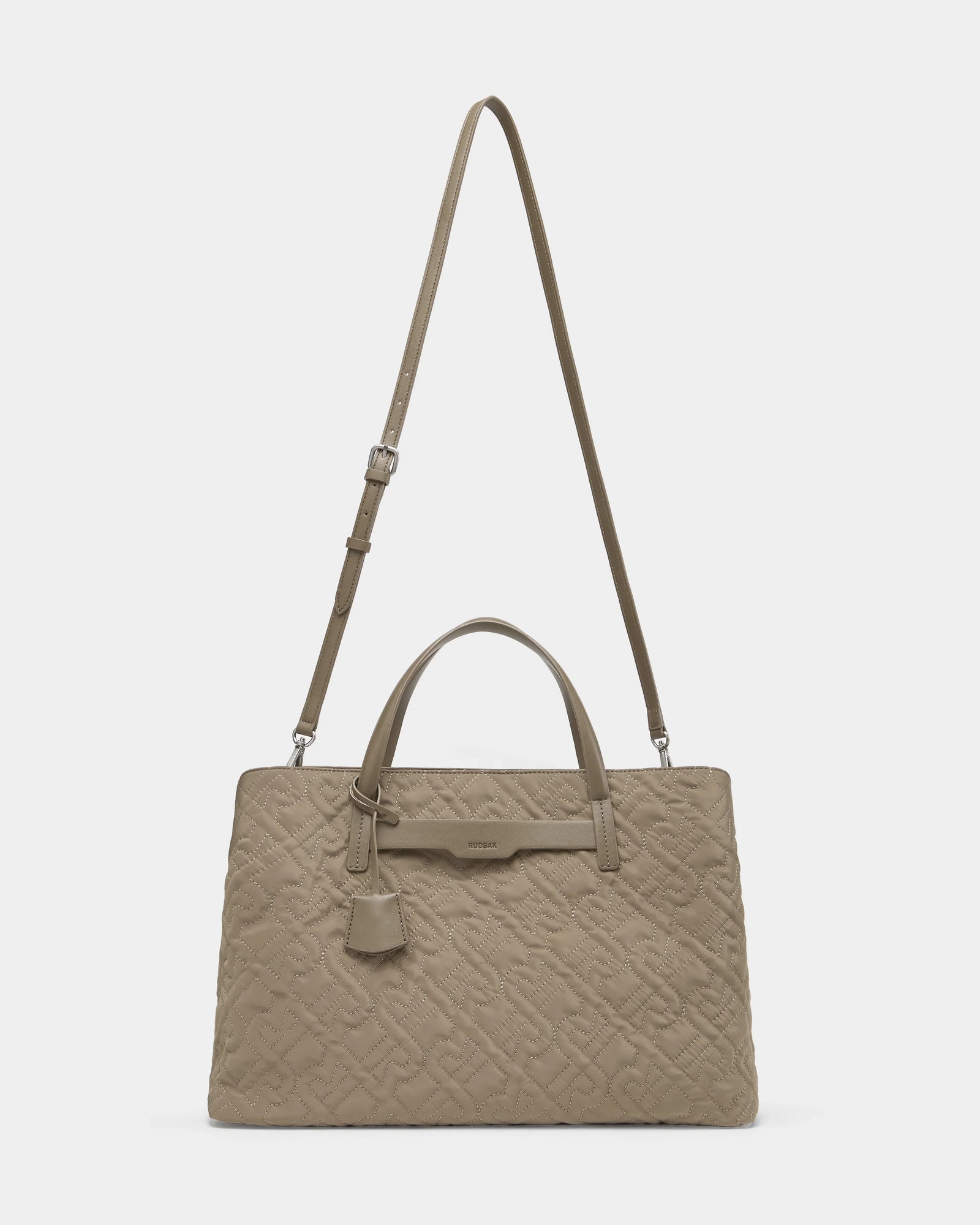 The Rudsak ASMINE - L325005 Almond bag features taupe quilted leather, two short handles, a long adjustable shoulder strap, and a small hanging tag, shown against a plain white background.