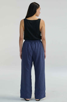 Woman wearing blue linen pants with a tie waist