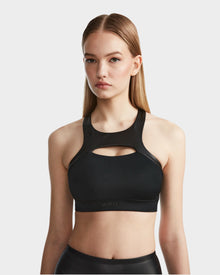 A woman wearing the RUDSAK ARYA - 8523002 BLACK sports bra, made from high-performance MVMT+ fabric.