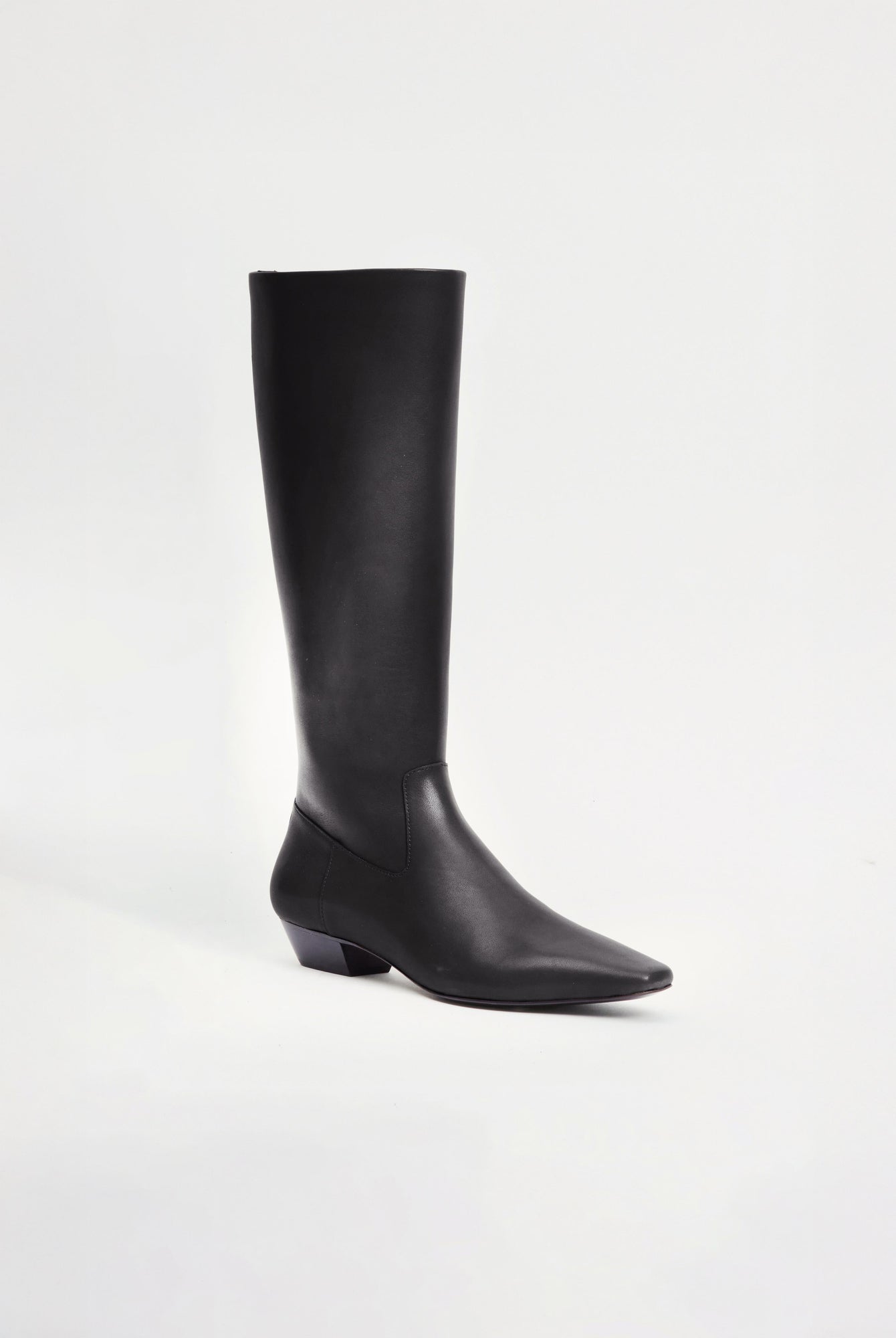 Black leather knee-high riding boot with pointed toe and low block heel.
