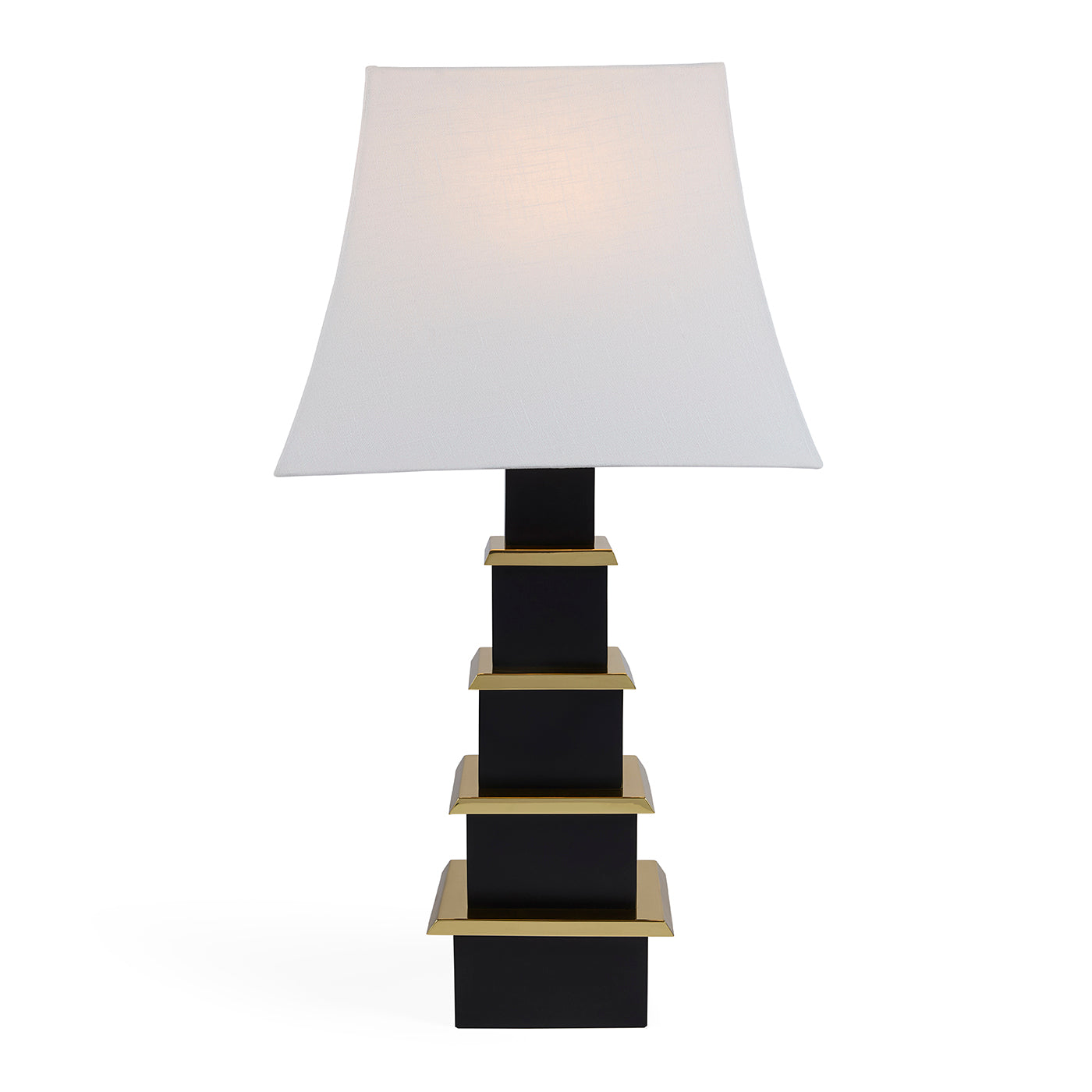 Table lamp with a white shade and black and gold base on a white background