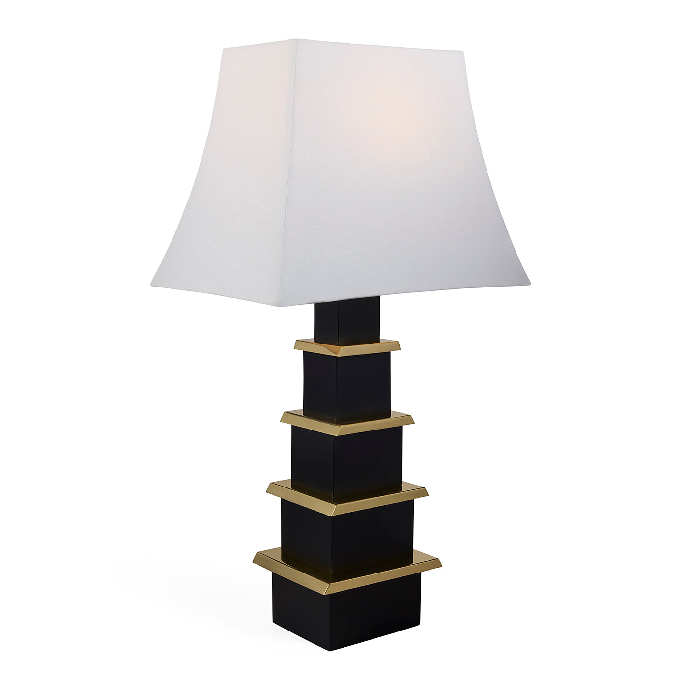 Table lamp with black and gold base and white shade on a white background