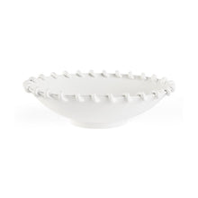 White ceramic bowl with textured rim on a white background