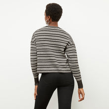 Back image of a woman wearing the tyler sweatshirt in black and white