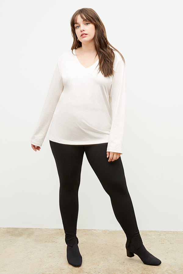 Front image of a woman standing wearing the stella legging in black | Exclude